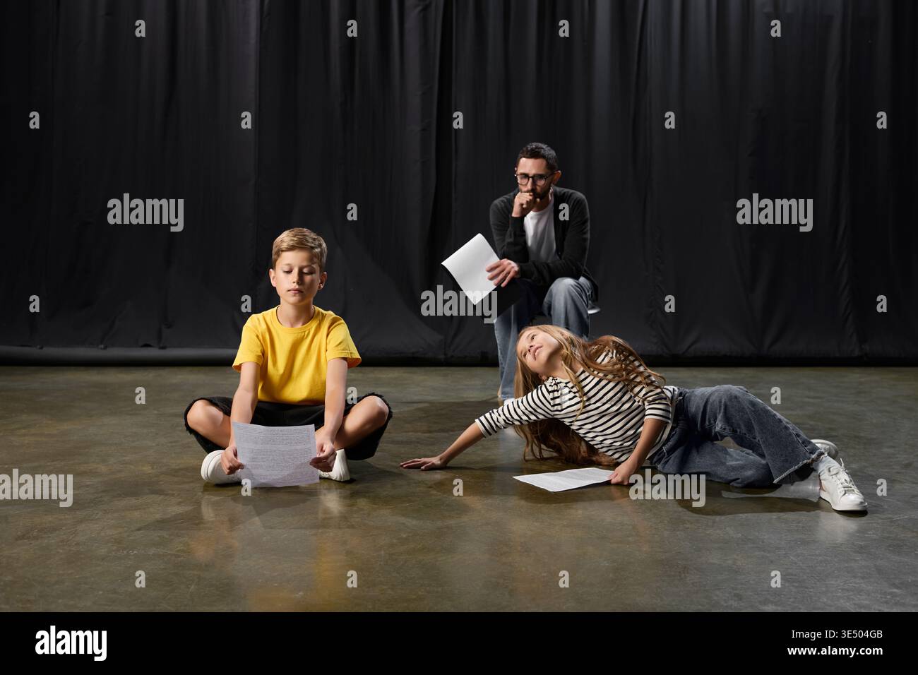A dedicated male teacher guides children in playful theater activities ...