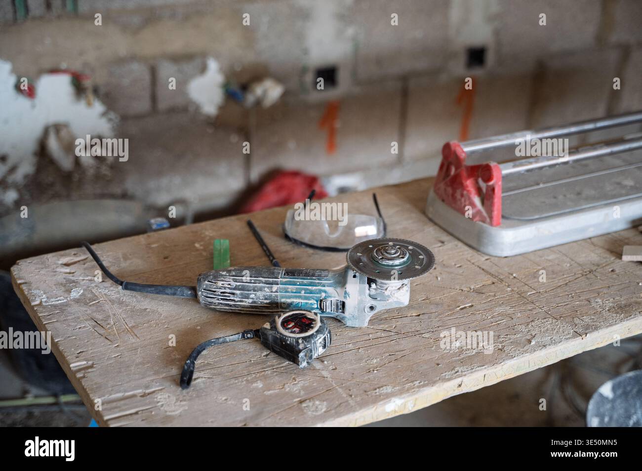 Construction tools on workbench with angle grinder – home renovation concept Stock Photo