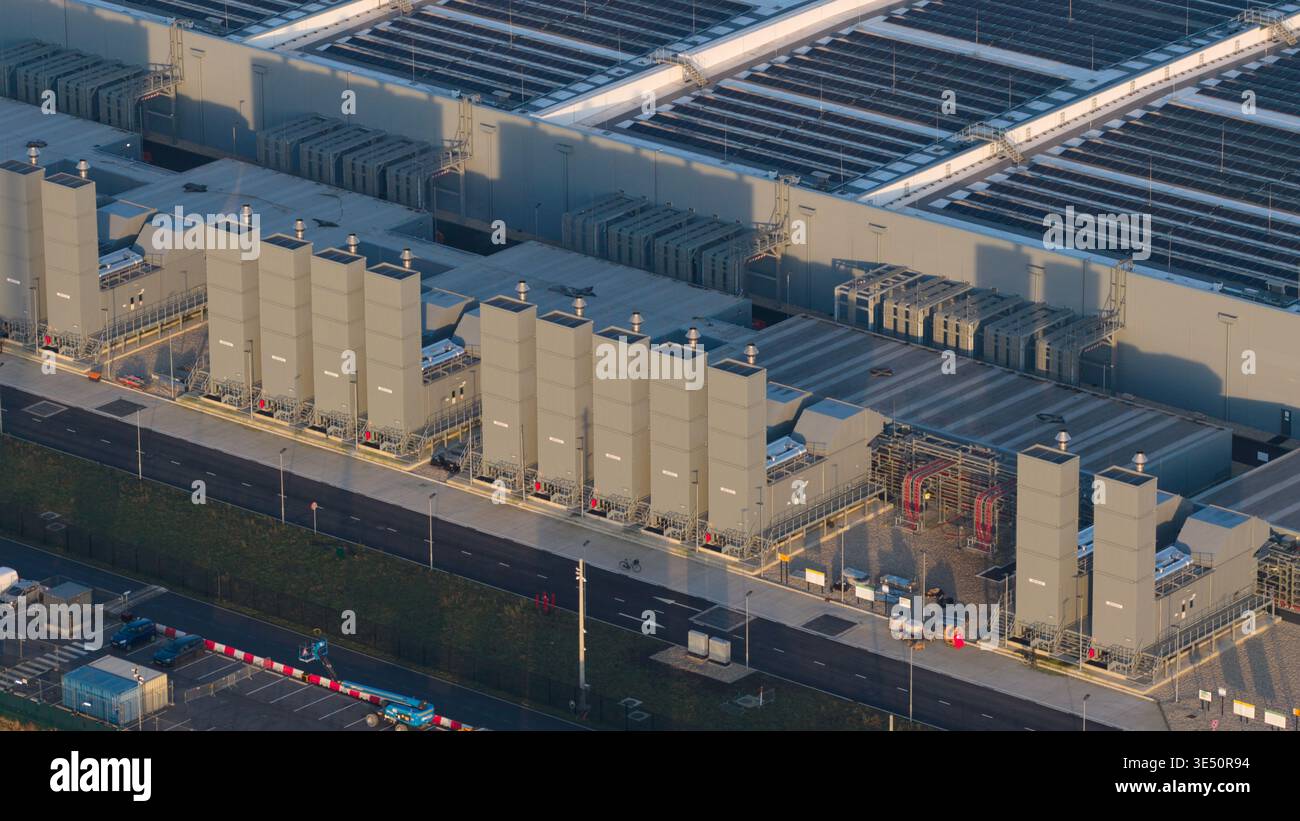 Aerial view of Datacenter Winschoten featuring industrial cooling towers, large roof structures, and solar panel arrays in Winschoten, Groningen, Neth Stock Photo