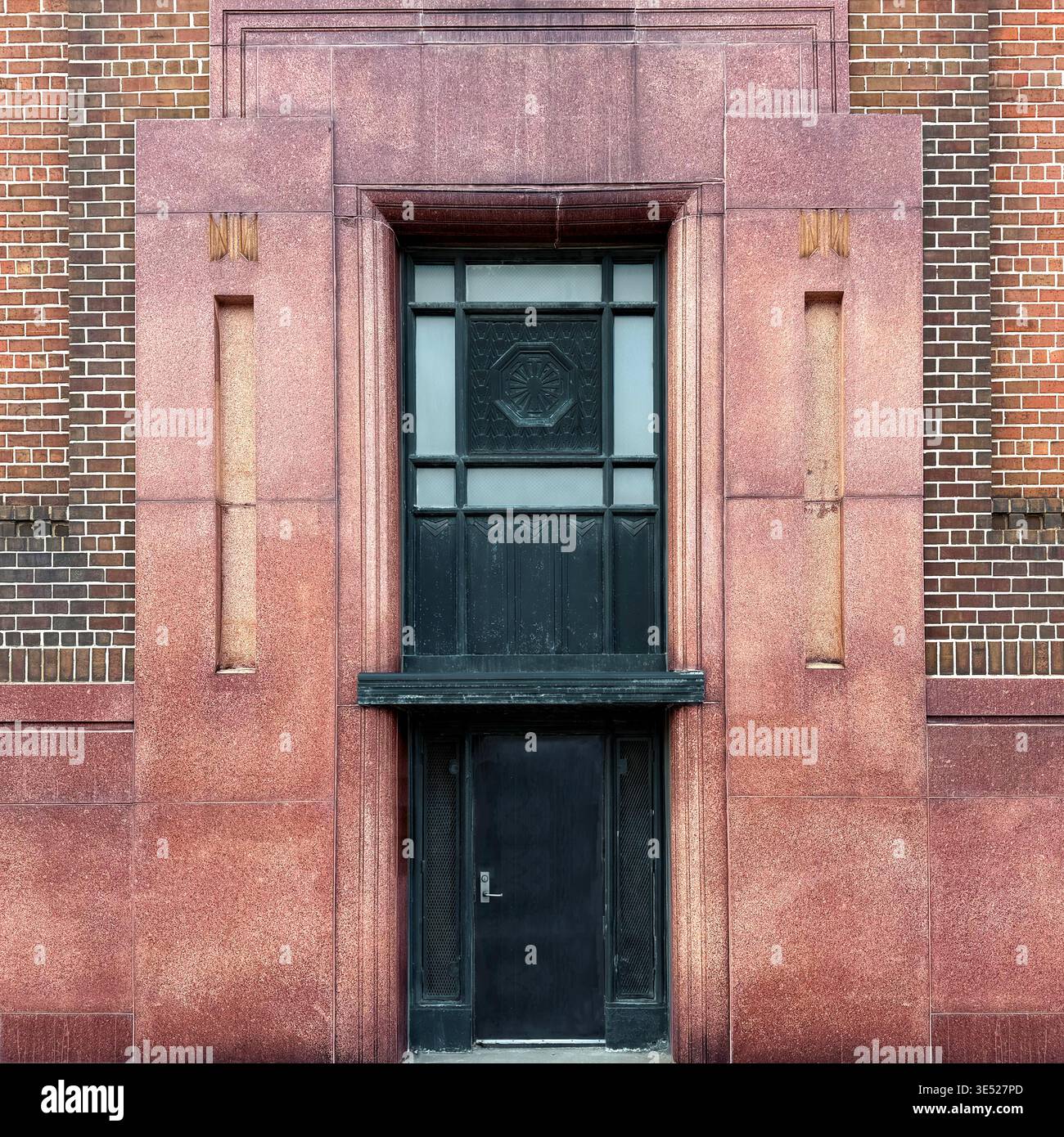 Art Deco doorway and window with geometric bas-relief in red stone, Chicago. - Smartphone Captured Stock Image
