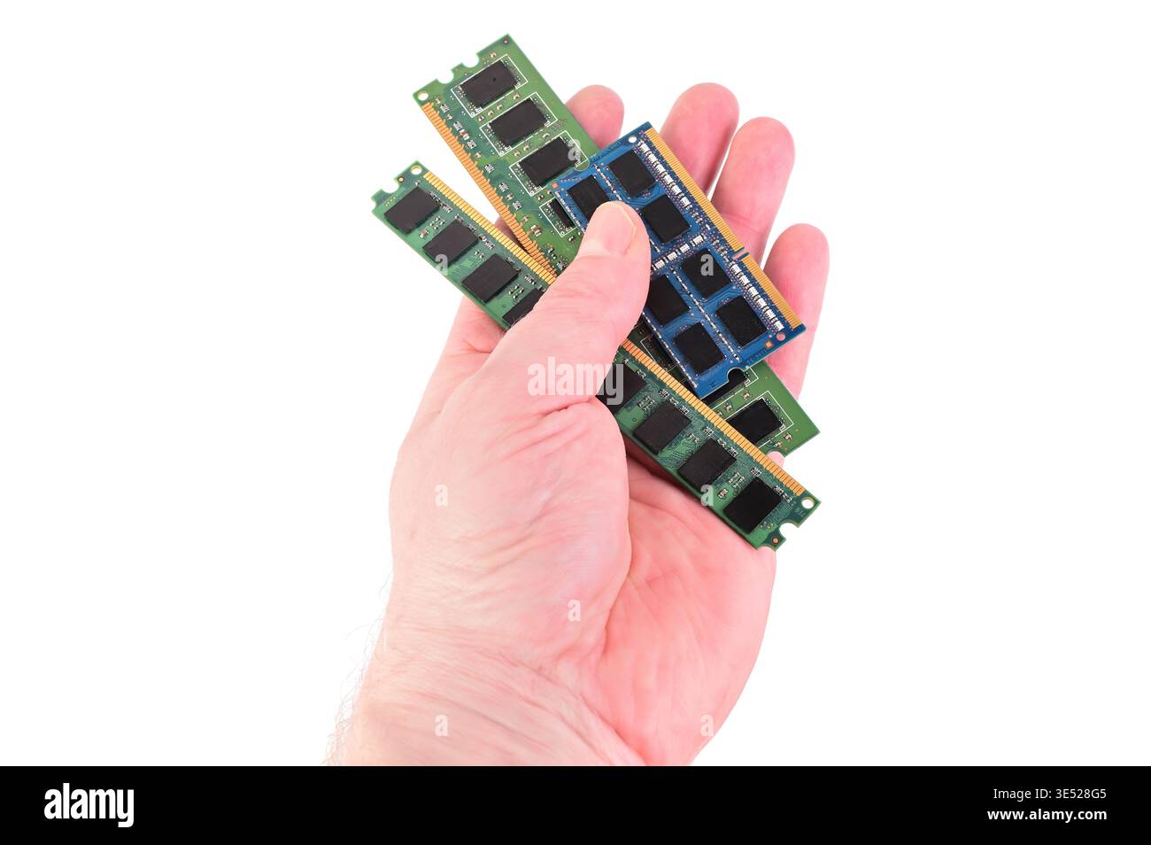 Hand holding multiple computer RAM modules for upgrade or repair Stock Photo