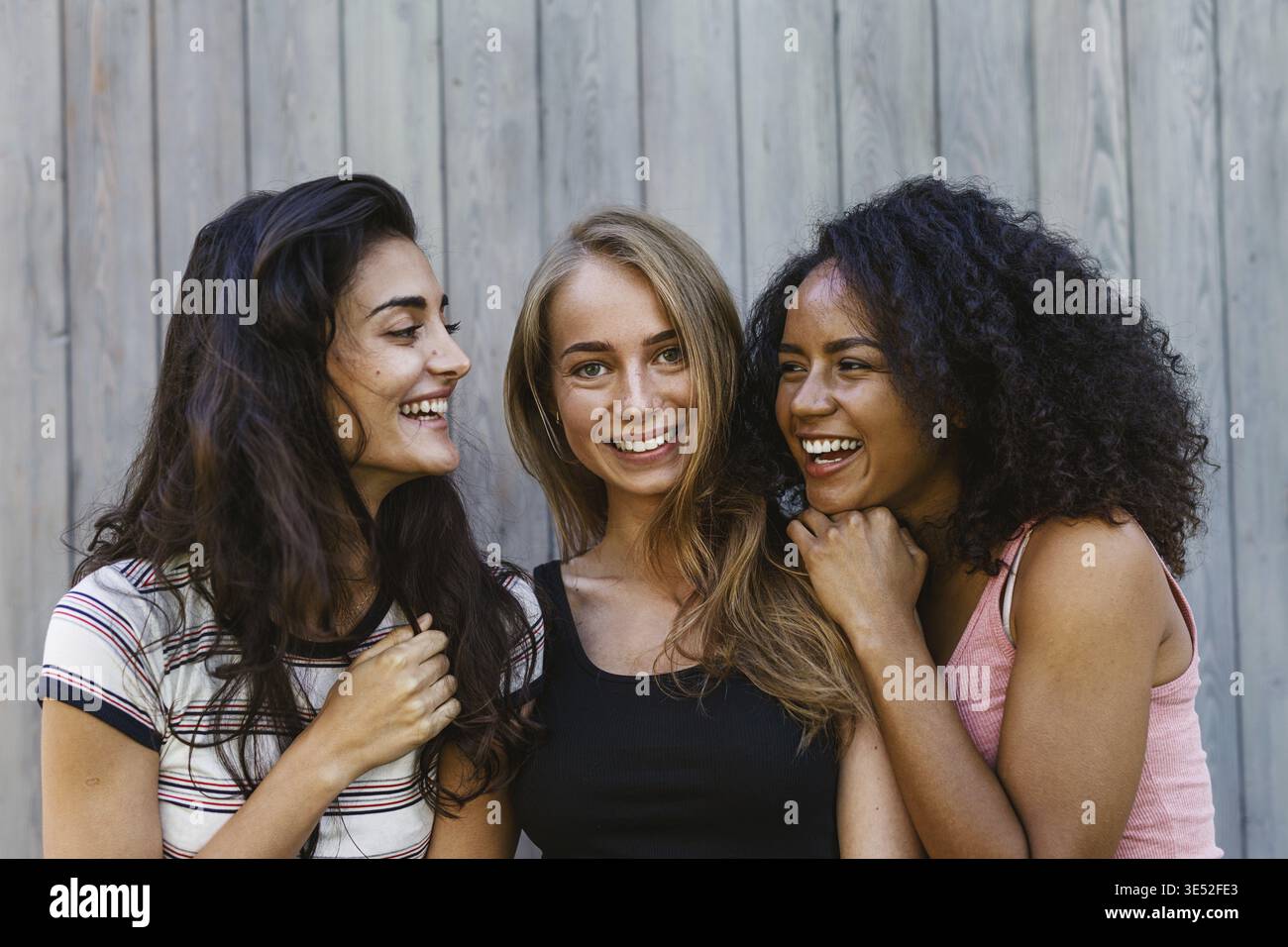 Three beautiful young women having fun outdoors Stock Photo