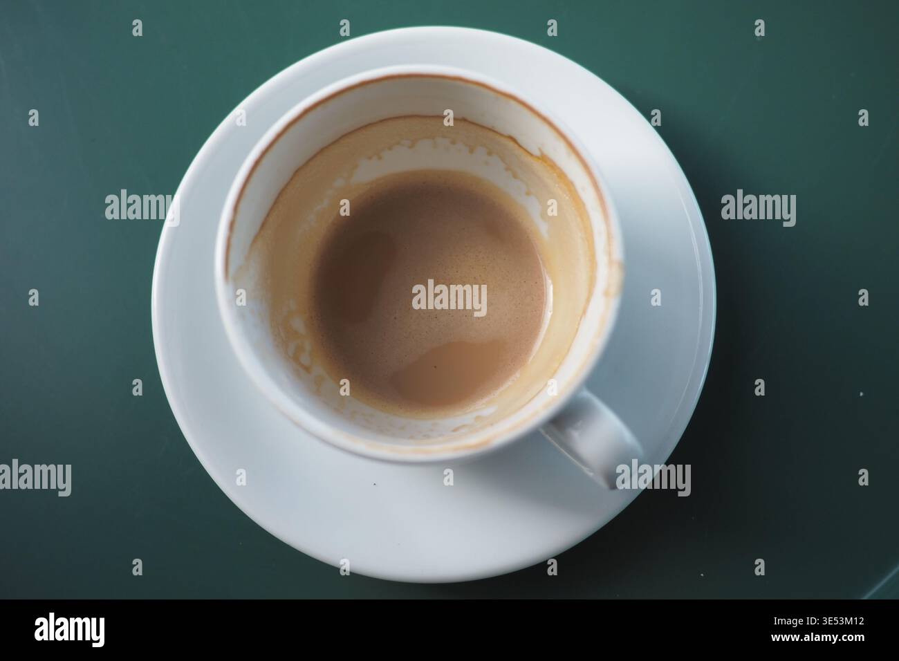 Coffee cup on a white plate with a dark green background Stock Photo