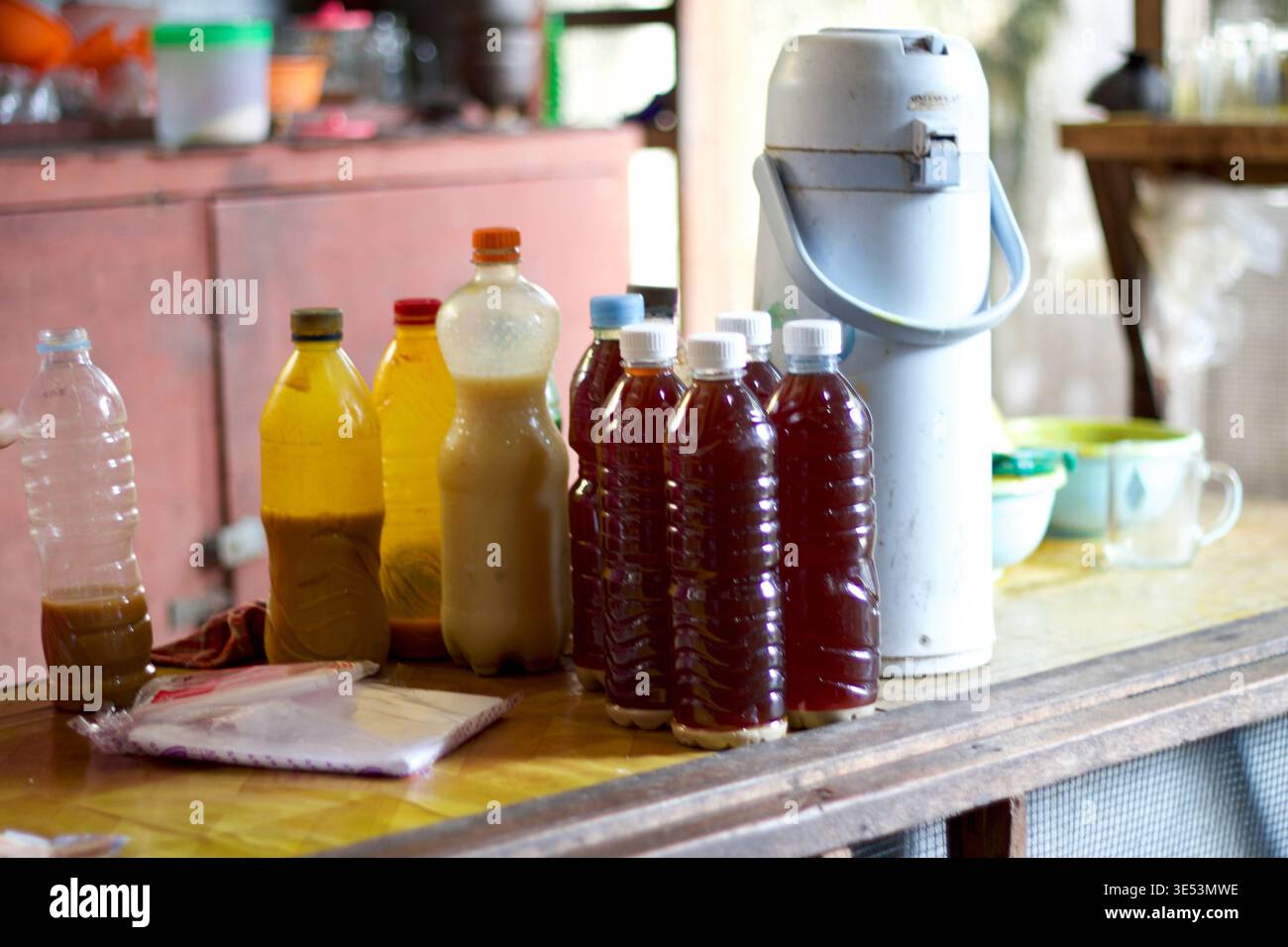 Homemade jamu bottles on table in Yogyakarta, Indonesia, showing traditional herbal drinks and local preparation. Stock Photo