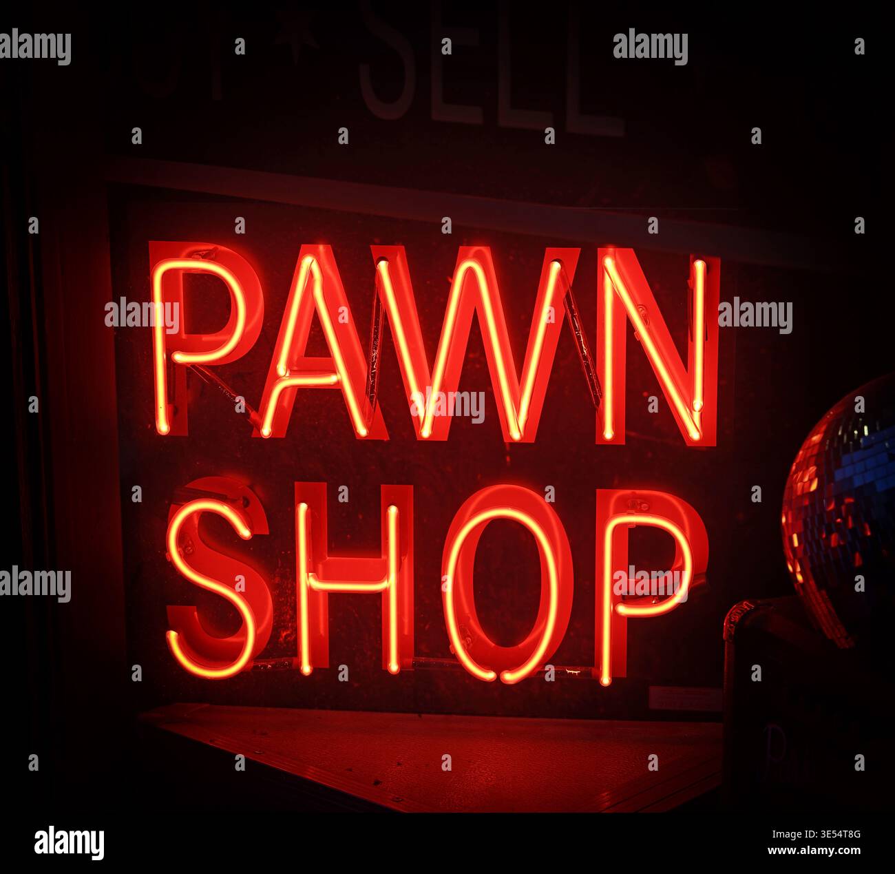 Red neon pawn shop sign in a dark shop window, illustrating deprivation, inflation, rising bills, fuel poverty and household financial hardship Stock Photo