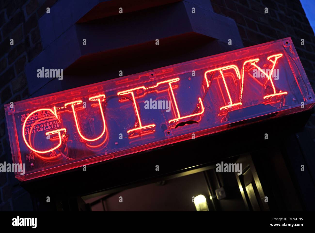 Guilty in red neon sign, United Kingdom. Stock Photo