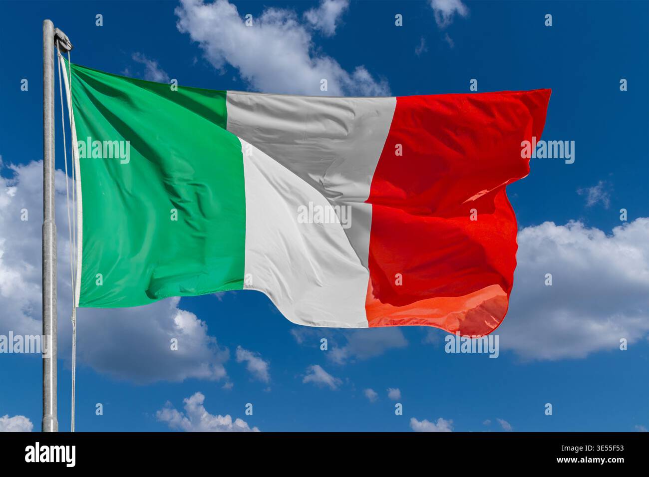 Italian tricolor flag waving in the wind on pole on blue sky with white ...