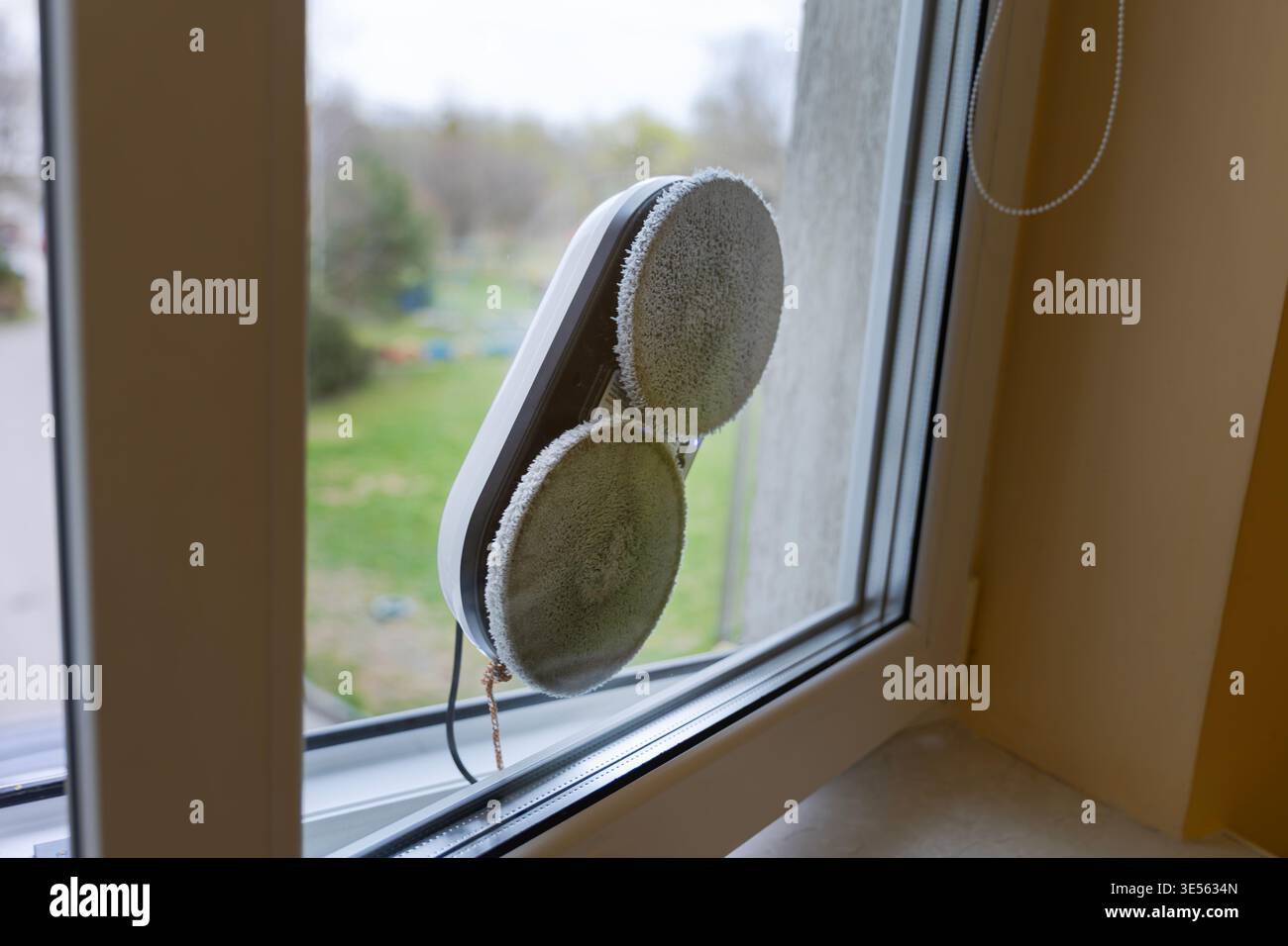 Automatic Robotic Window Cleaner Working on a Glass Surface Stock Photo