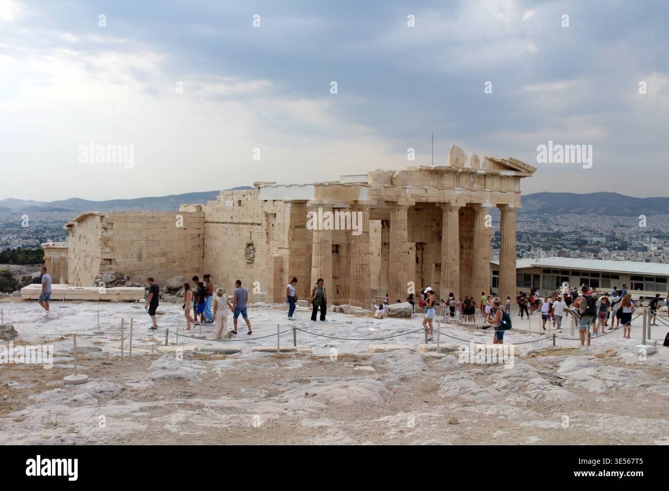 Tourists around Propylaea Monumental Entrance Gate August 2024 Classical greek stone columns and ruins Athens Greece Stock Photo