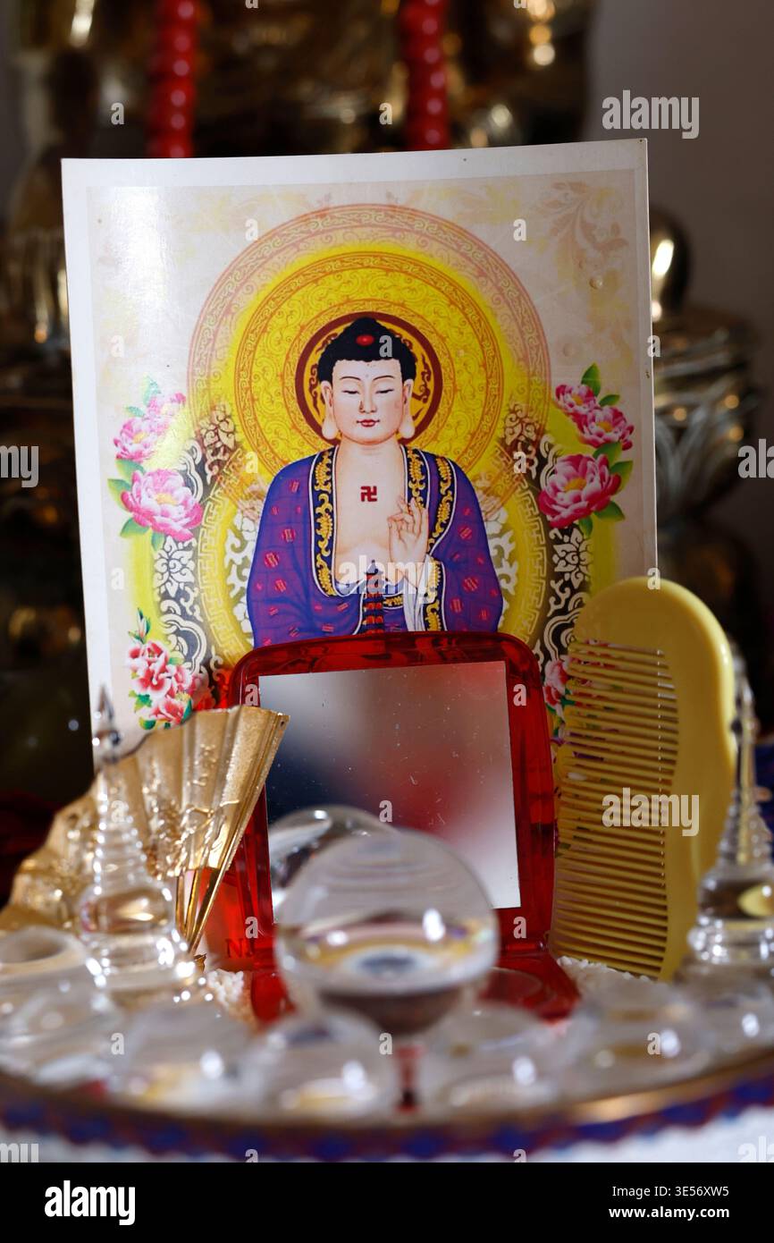 Buddhist shrine detail with illustrated Amitabha Buddha card, mirror ...