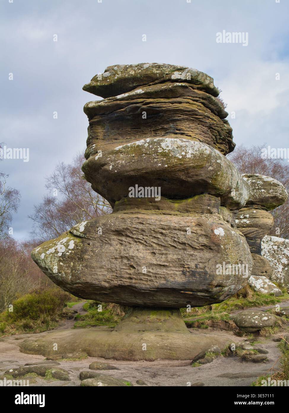 Yorkshire, UK - Mar 16 2026: Weathered balancing stones rise at Brimham Rocks in Yorkshire UK, creating a dramatic natural landmark under a bright cloud filled sky Stock Photo