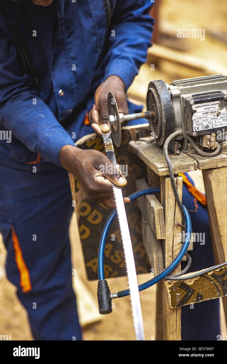 Worker in a carpentry workshop in Kigali, Rwanda Stock Photo