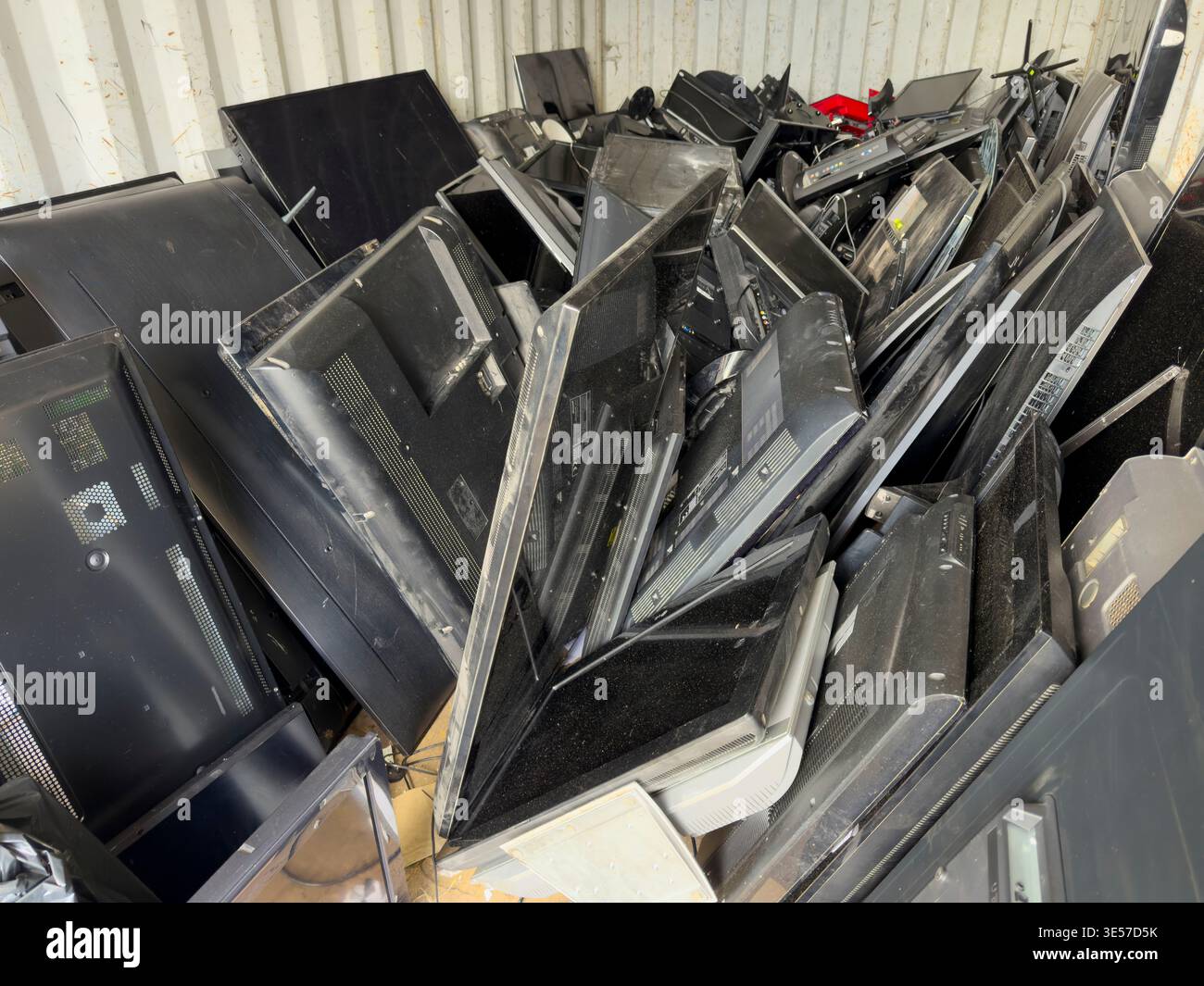 Discarded televisions stacked in shipping container for recycling, electronic waste management and sustainability concept: Phillip Roberts - Smartphone Captured Stock Image
