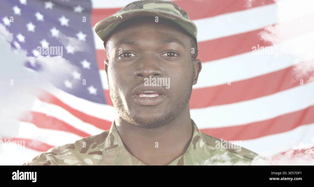 Standing man in camouflage uniform and patrol cap speaking in studio with American flag backdrop Stock Photo