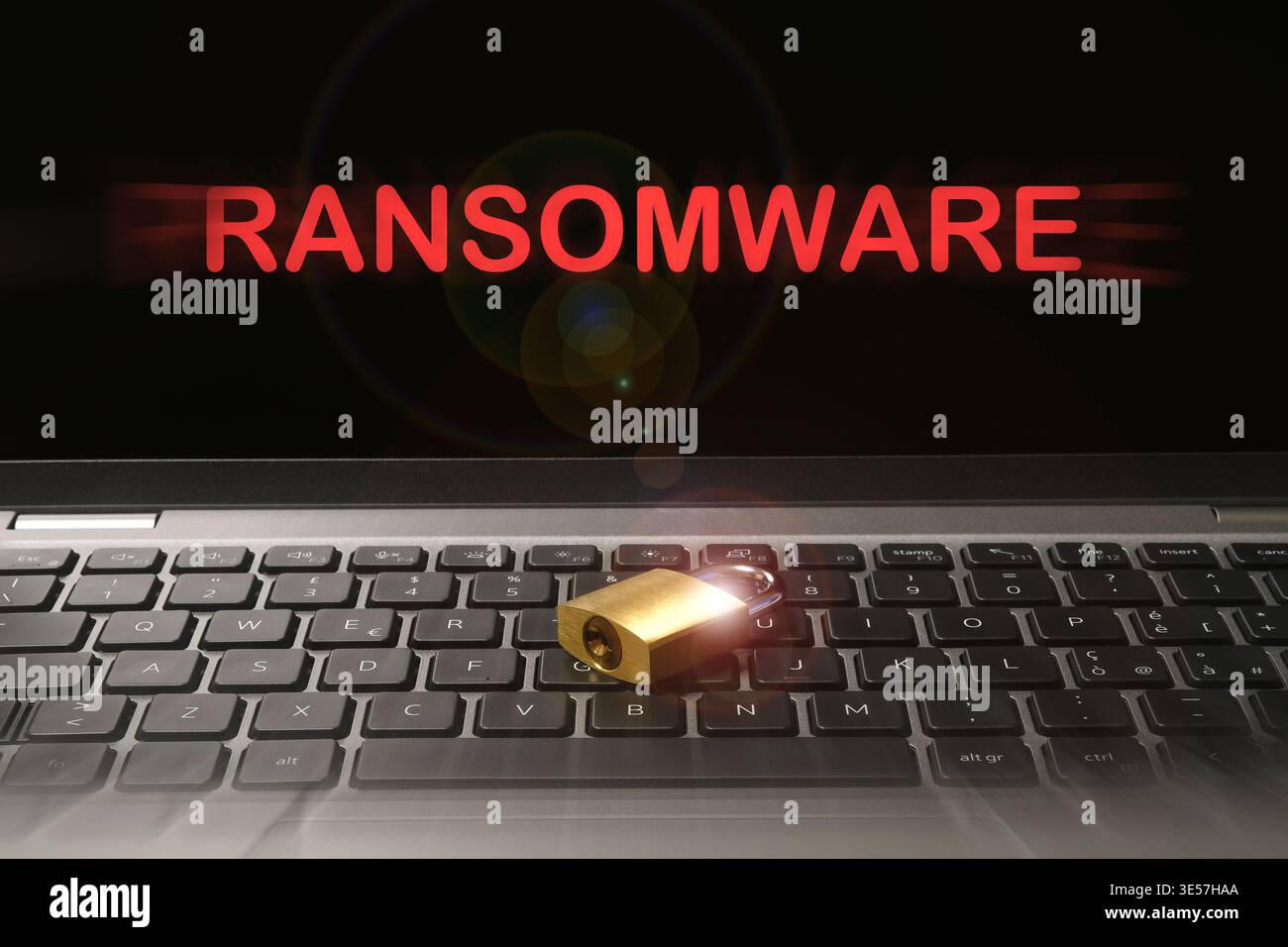 Computer security concept with a closed padlock on the laptop keyboard and "Ransomware" text on the screen. Cyber threat concept image. Stock Photo