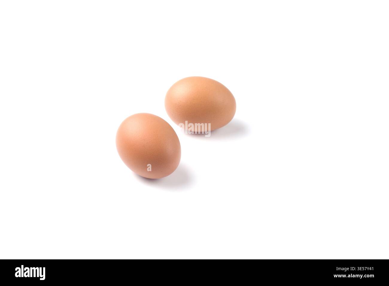 Two brown-shelled eggs. Fresh eggs on a white Stock Photo