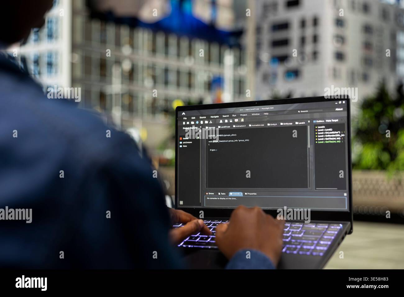 Writing code, laptop closeup and software developer on park bench implementing algorithms. freelancing outdoors, notebook display and programmer using programming languages script program Stock Photo
