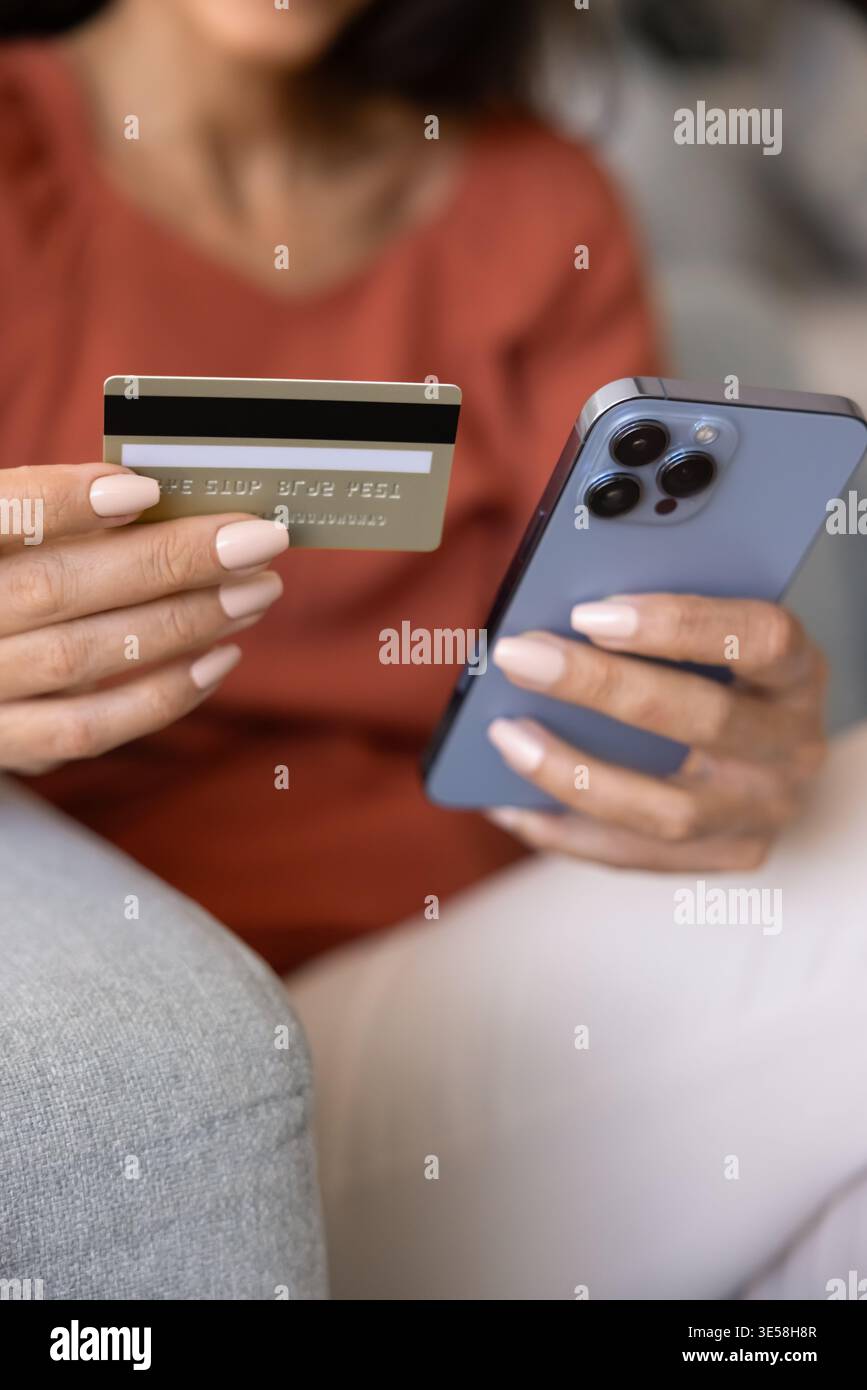 Close up female hands holding credit card and phone Stock Photo