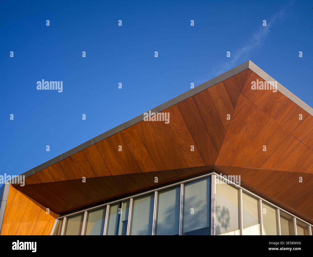 Upward perspective of a modern commercial building featuring a striking ...