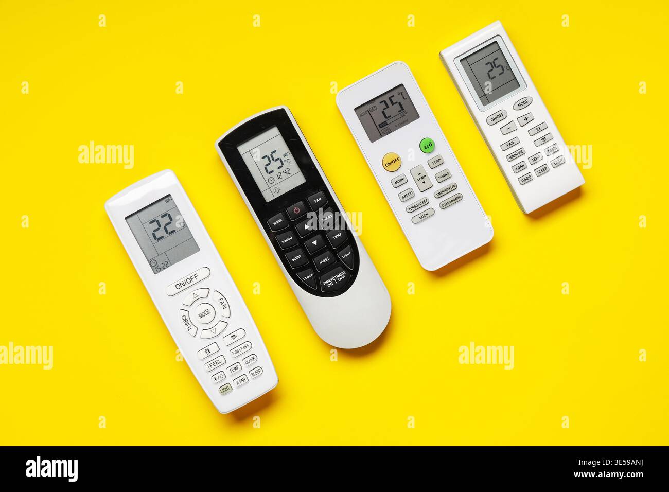 Air conditioner remote controls on yellow background Stock Photo