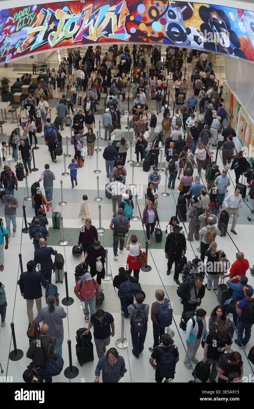 FILE - Travelers line up at a TSA checkpoint at George Bush ...