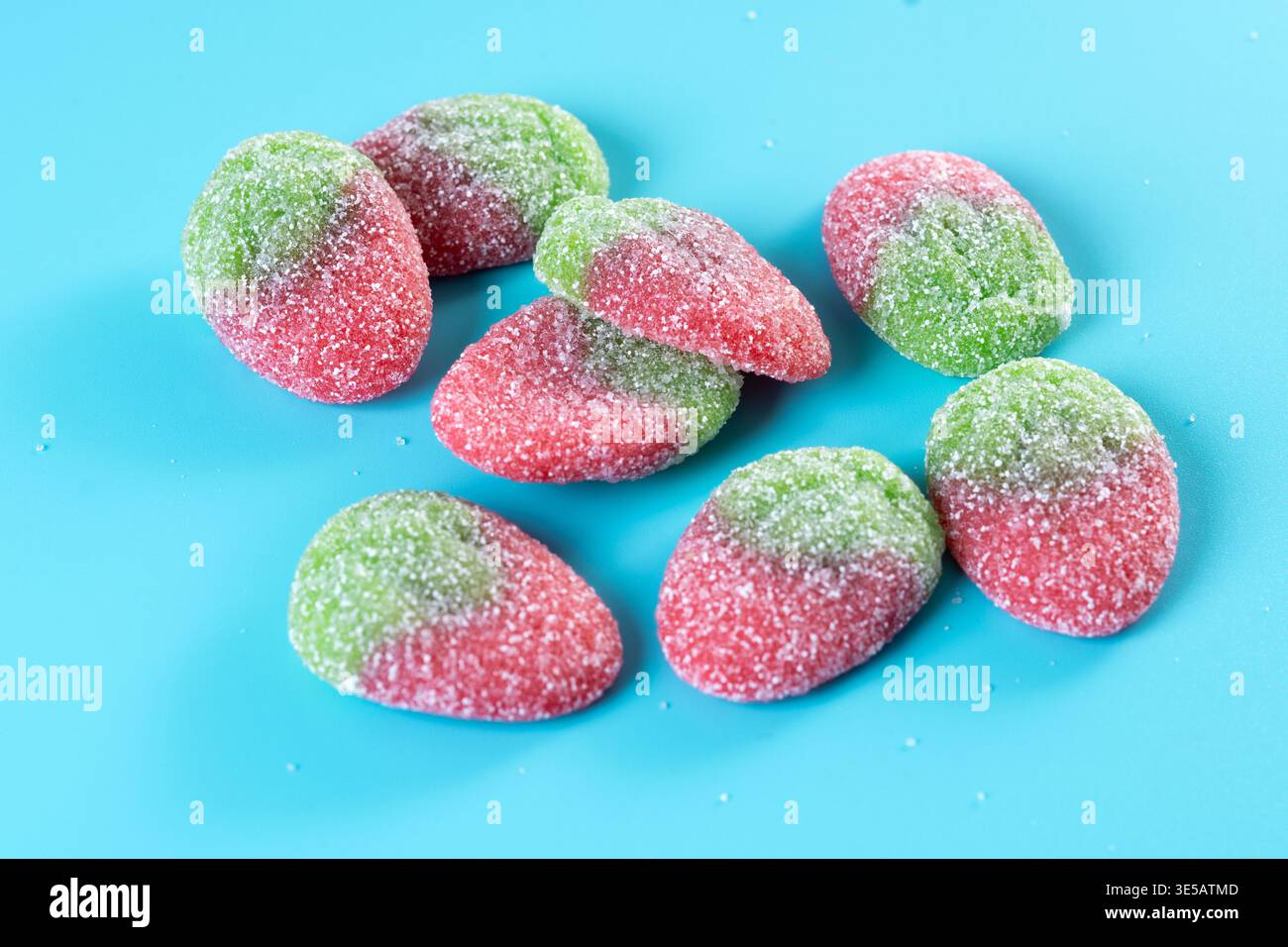 Strawberry candies on blue background Stock Photo