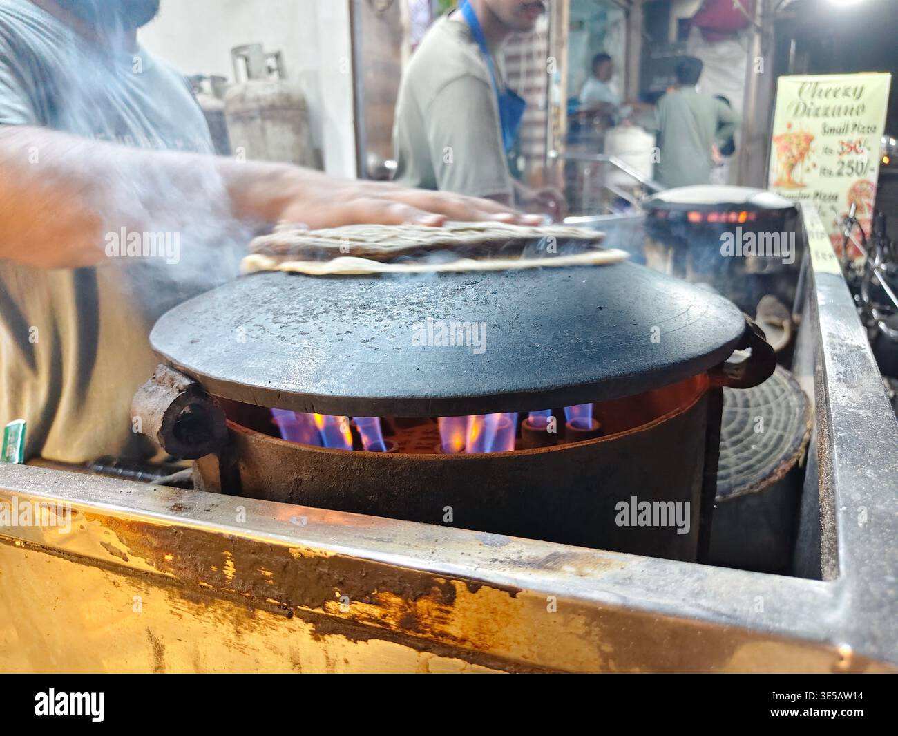 Karachi, Pakistan - March 31, 2026: Chapati Roti cooking at hotel road ...