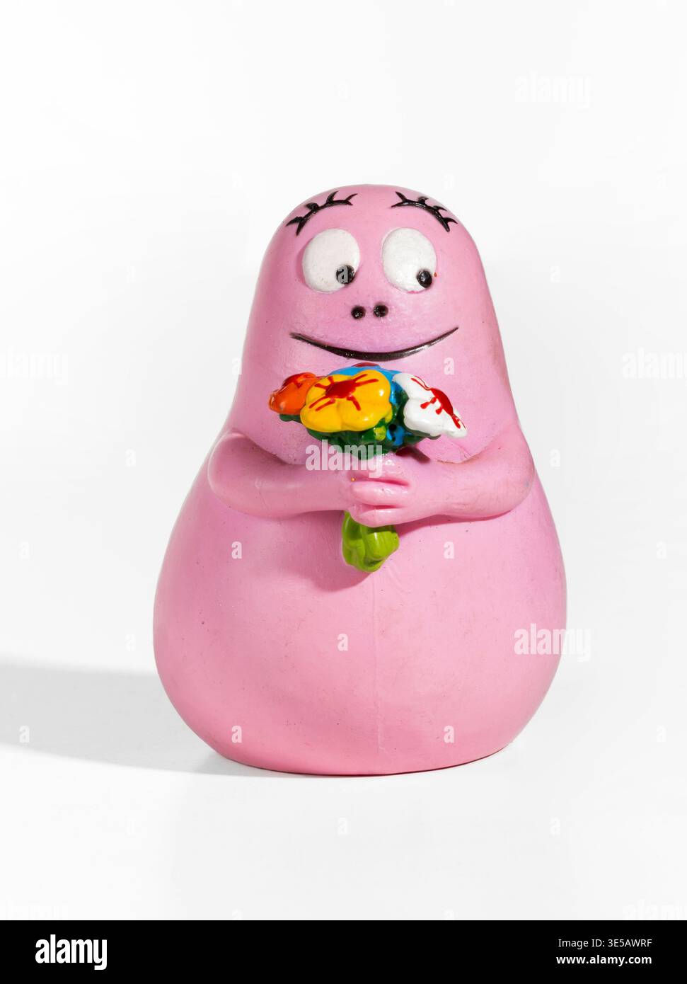 Milan, Lombardy, Italy- February 04, 2026: Barbapapa character figurine holding a colorful bouquet of flowers on white background Stock Photo