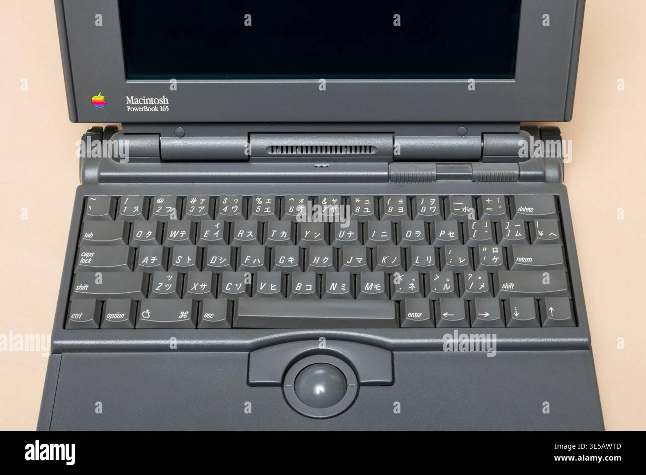 Pavia, Lombardy, Italy - November 02, 2024: Vintage Apple Macintosh PowerBook showing detail of its gray keyboard and trackball. Shown at Ctrl+Alt Mus Stock Photo