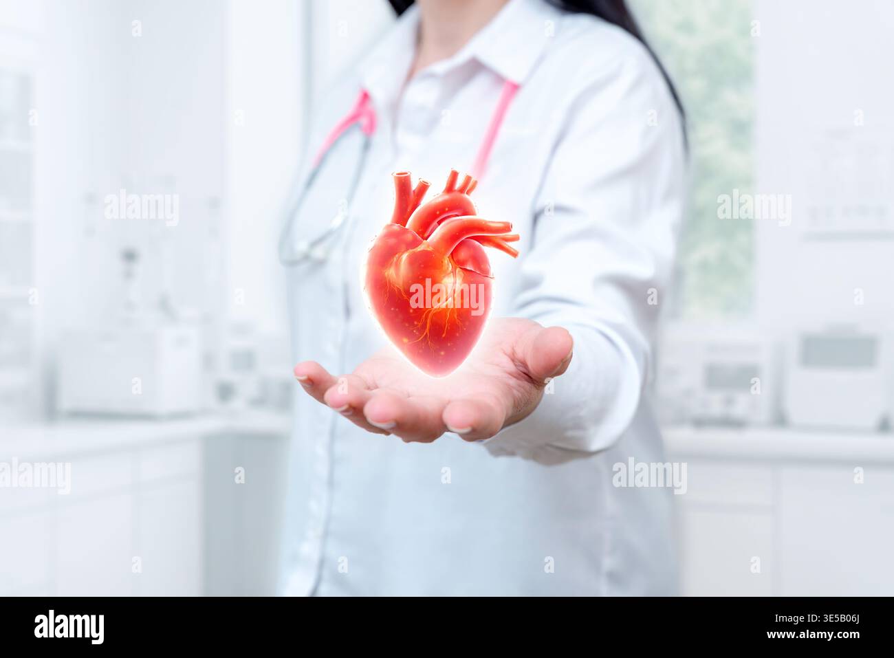 Doctor holding glowing human heart model, representing cardiology, heart health, medical care, and cardiovascular treatment concept Stock Photo