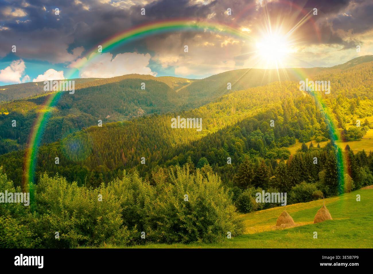 sunset over mountain hay field. alpine countryside summer landscape with green valley behind the woods on the grassy slope. cloudy sky. spectacular hi Stock Photo