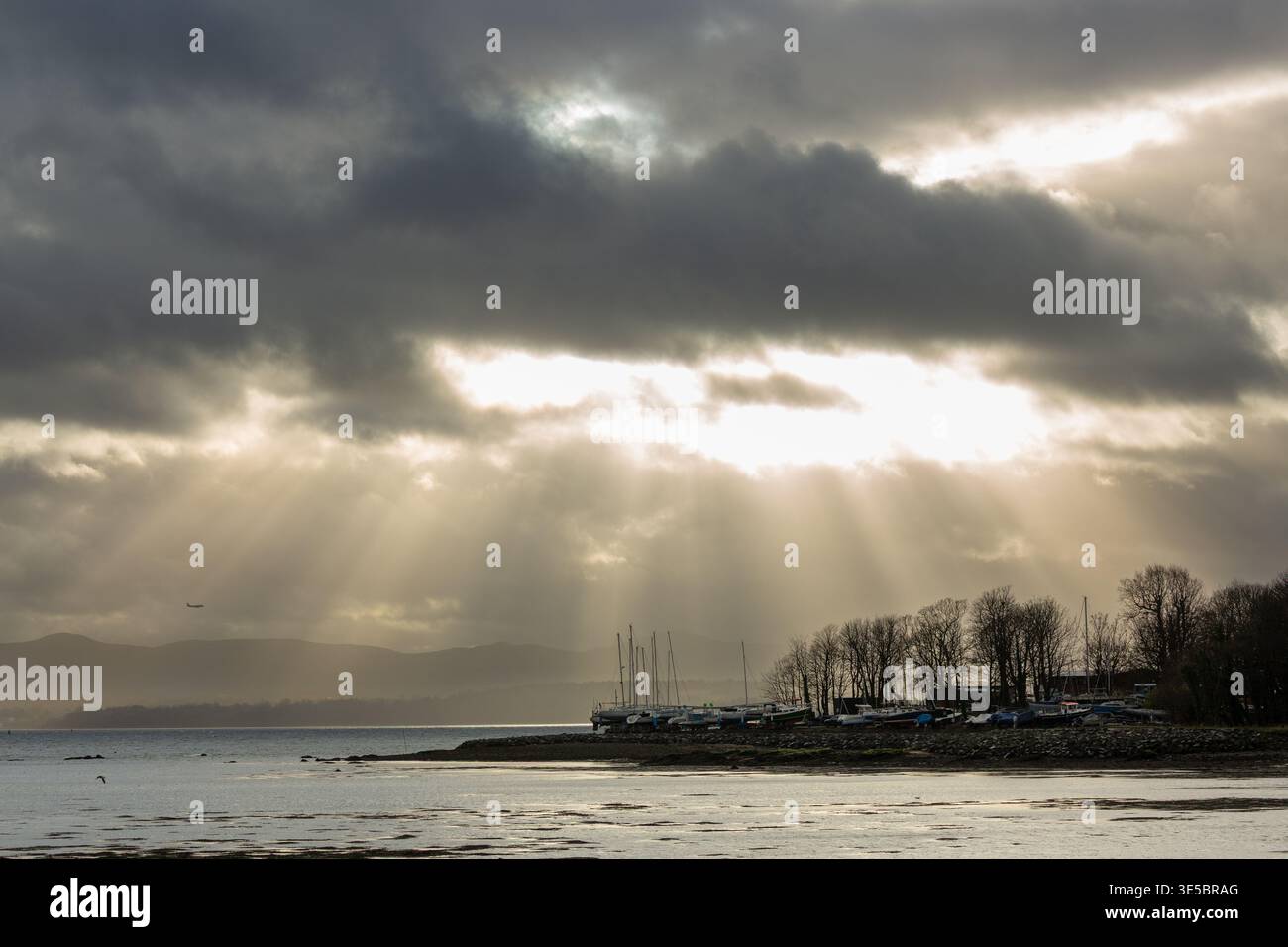 Rays of light breaking through winter clouds Dalgety Bay, Fife, Scotland Stock Photo