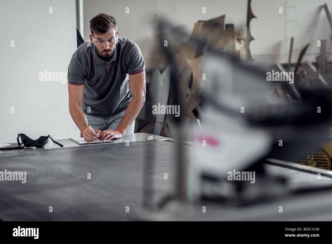 Male engineer setup plasma cutter for work in metalwork workshop. Stock Photo