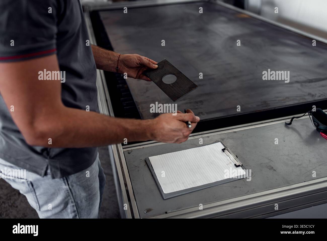 Male engineer setup plasma cutter for work in metalwork workshop. Stock Photo