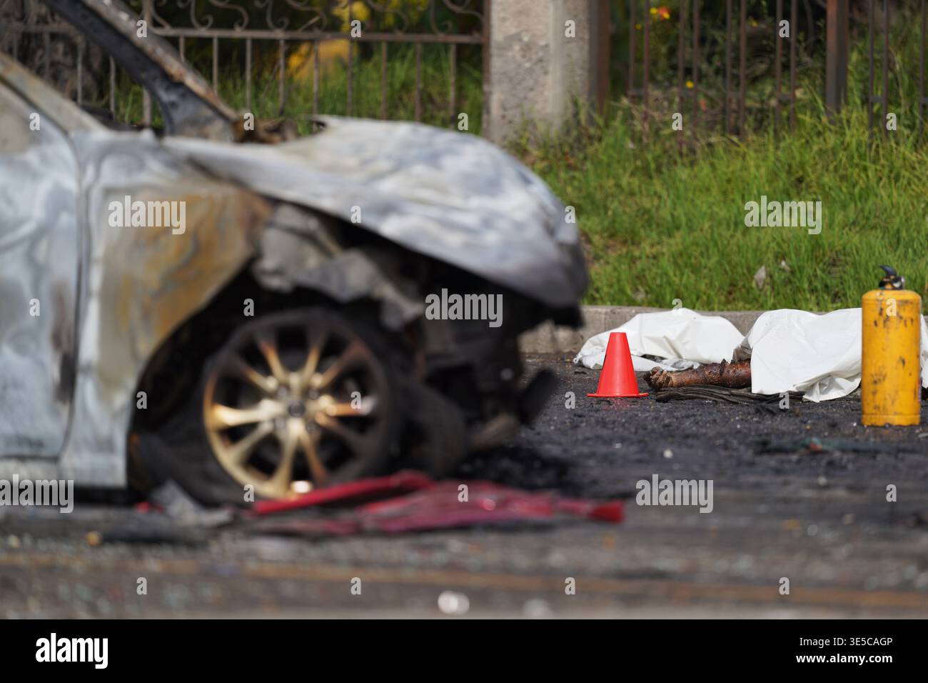 A body lies next to a burned car after a multiple vehicle accident in ...