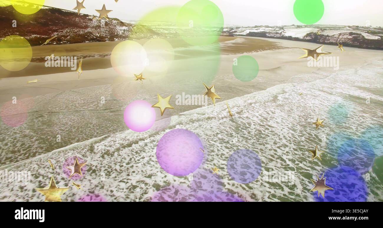 Crashing waves forming foam line over wet sand at aerial view, with colored bokeh, gold stars Stock Photo