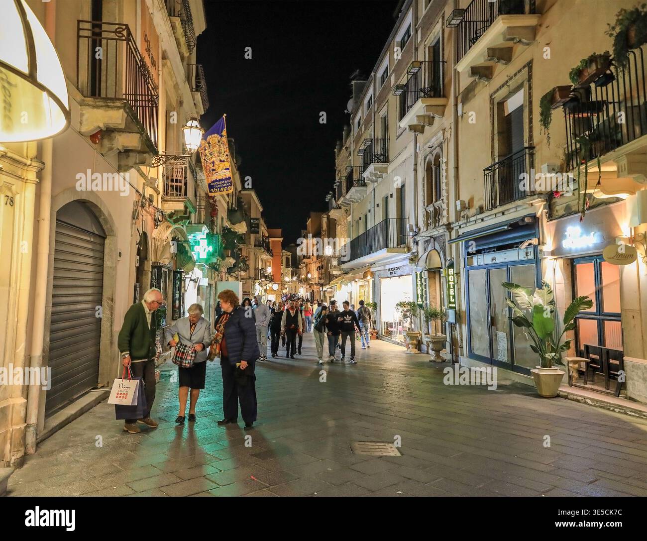 Night time at Corso Umberto, a street busy with tourists in the centre of Taormina, Sicily, Italy, Europe Stock Photo