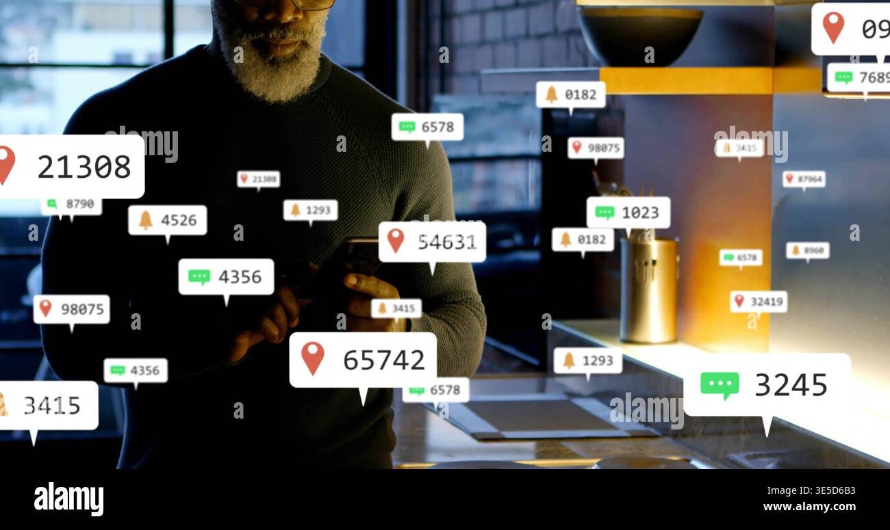 Checking senior man in dark knit sweater holding smartphone in workspace kitchen seeing alerts Stock Photo