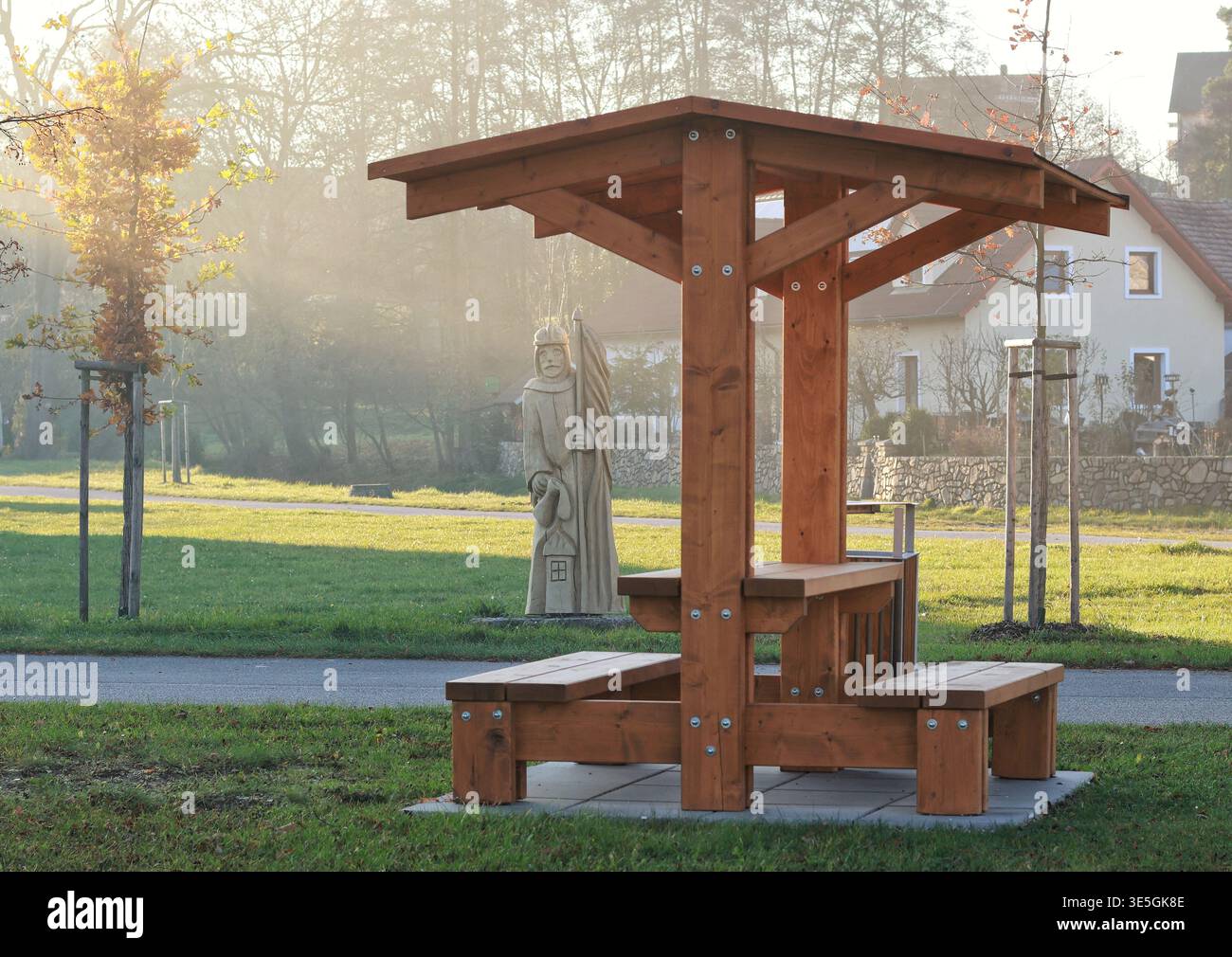 A new wooden picnic bench with a roof standing in a green park area at ...