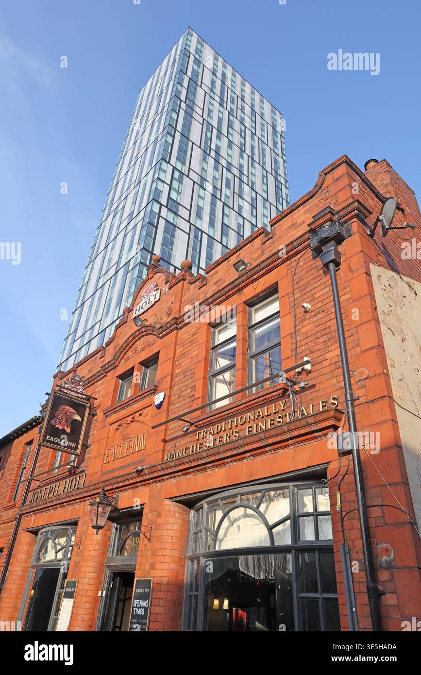 Historic Eagle Inn, Salford, a Victorian Joseph Holt pub with Holt’s finest ales signage, dwarfed by a modern Manchester skyscraper Stock Photo