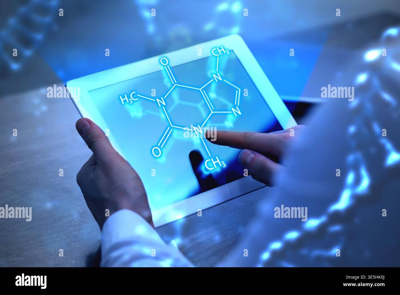 Scientist using tablet computer at table in laboratory, closeup. Skeletal formula above device. Biochemistry research Stock Photo