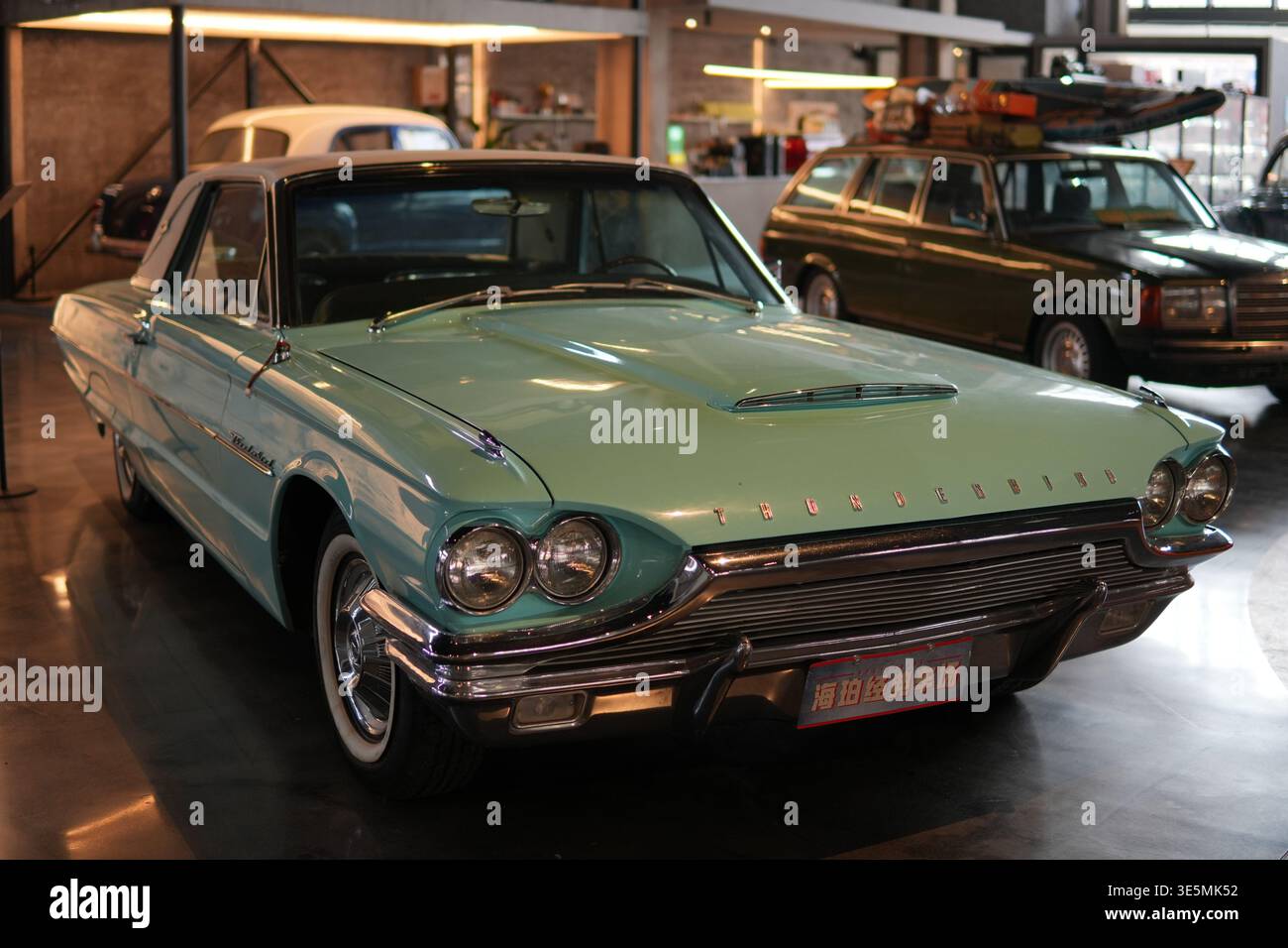 Shanghai march 2 2026 Turquoise Ford Thunderbird classic with chrome trim and whitewall tires on display in indoor showroom museum, vintage elegance Stock Photo