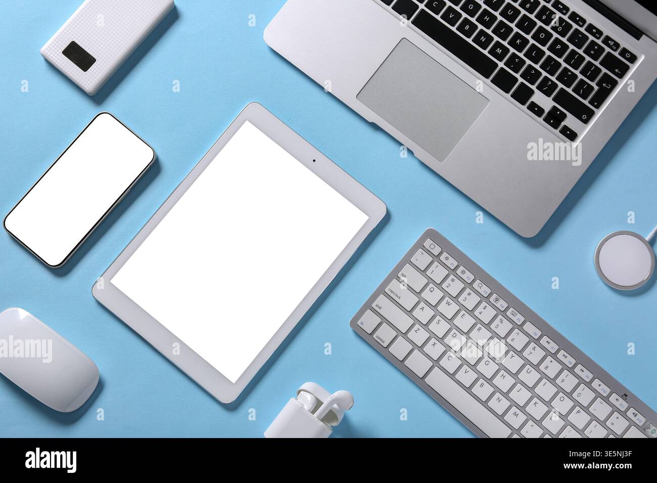 Tablet computer with different modern gadgets on blue background Stock Photo