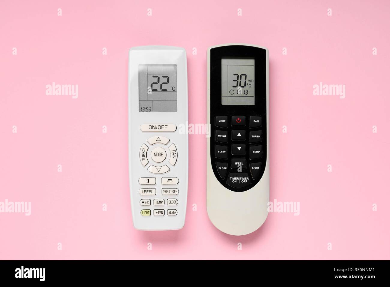 Air conditioner remote controls on pink background Stock Photo