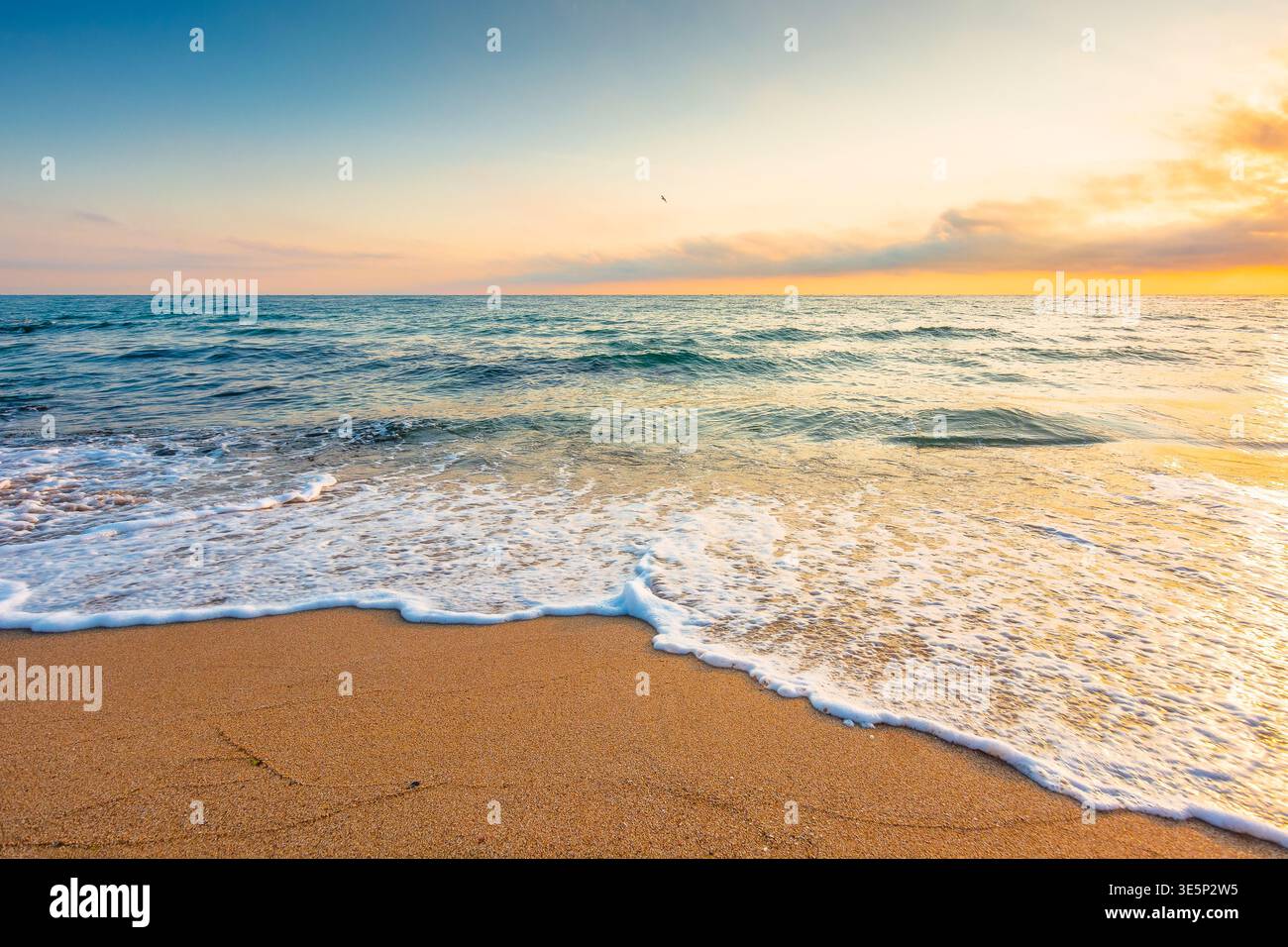 autumn vacation at the sea. beautiful seascape at sunrise. calm waves wash the sandy beach. image with fluffy clouds on the sky above horizon. perfect Stock Photo