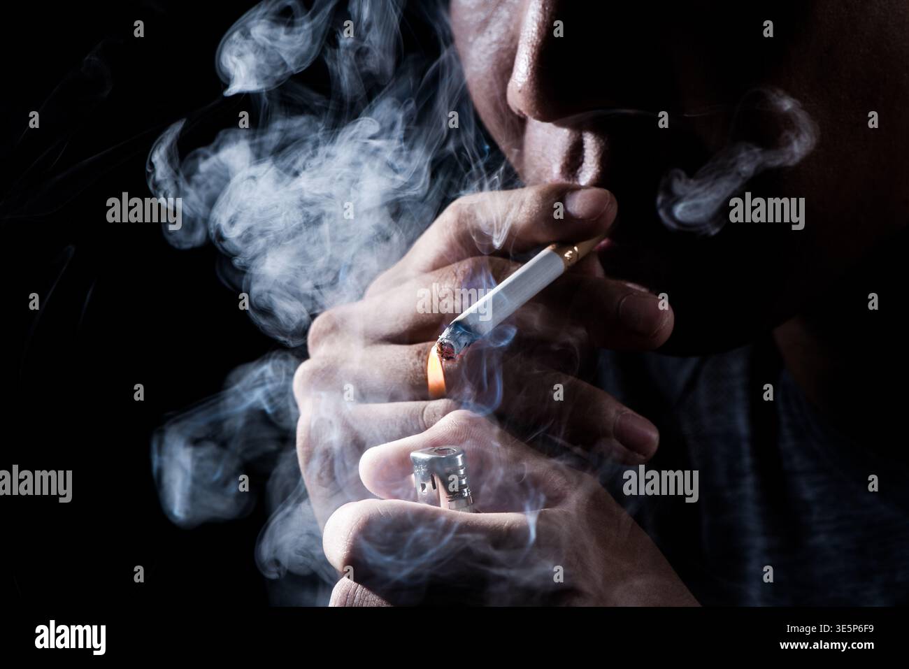 Man cigarette lighter smoking hi-res stock photography and images