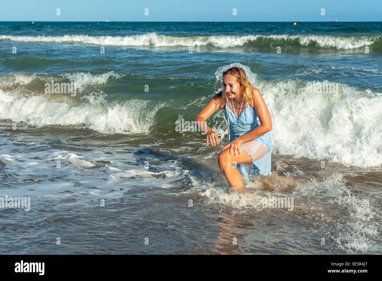 Woman in dress wading in water hi-res stock photography and images - Alamy