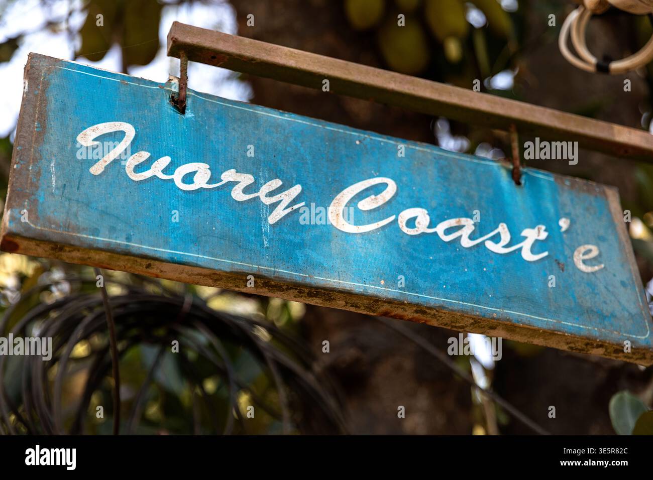 Hand-painted rustic sign with Ivory Coast text in a street of Kannur, South India Stock Photo