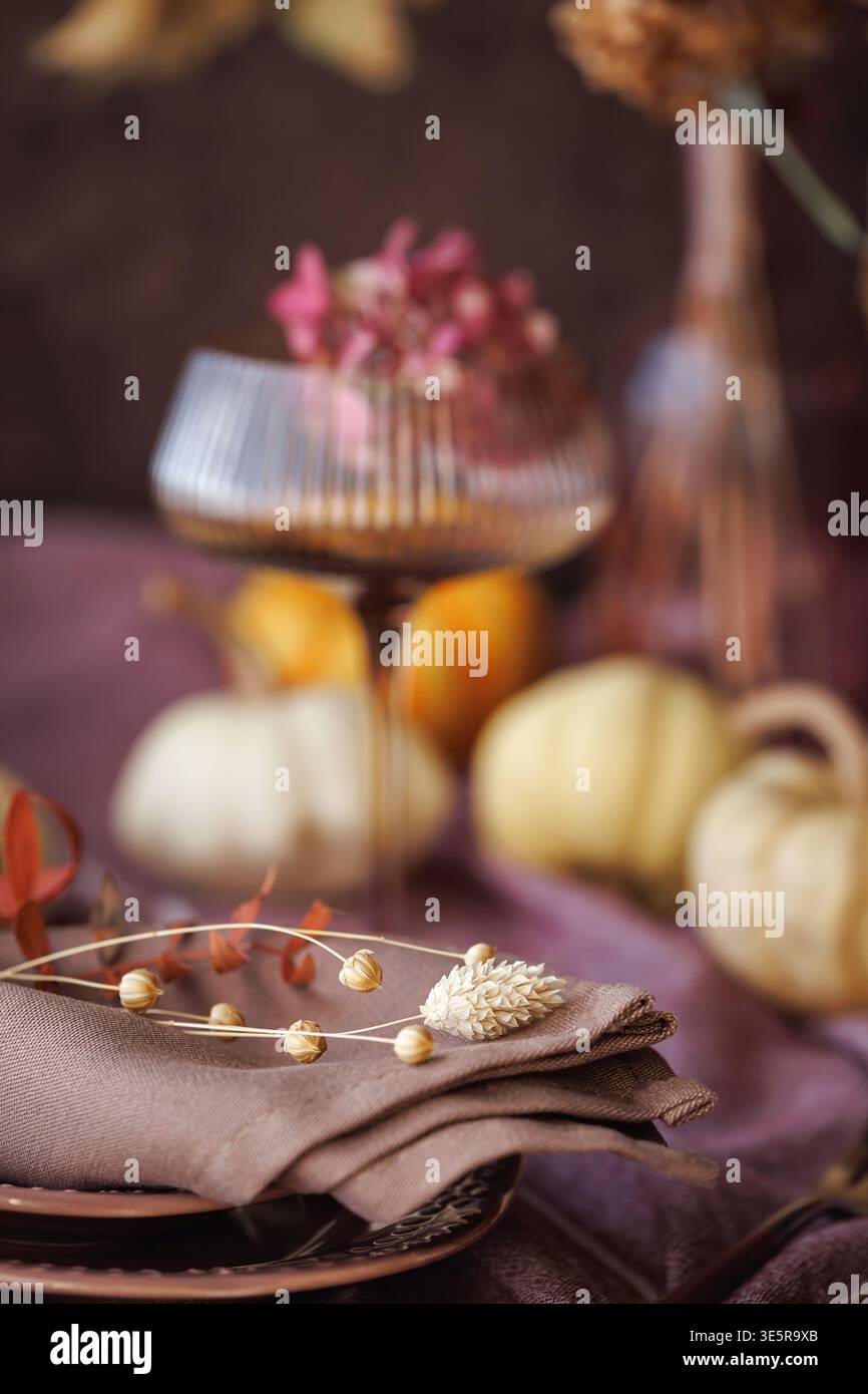 Fall-inspired table setting with pumpkins and dried flowers Stock Photo