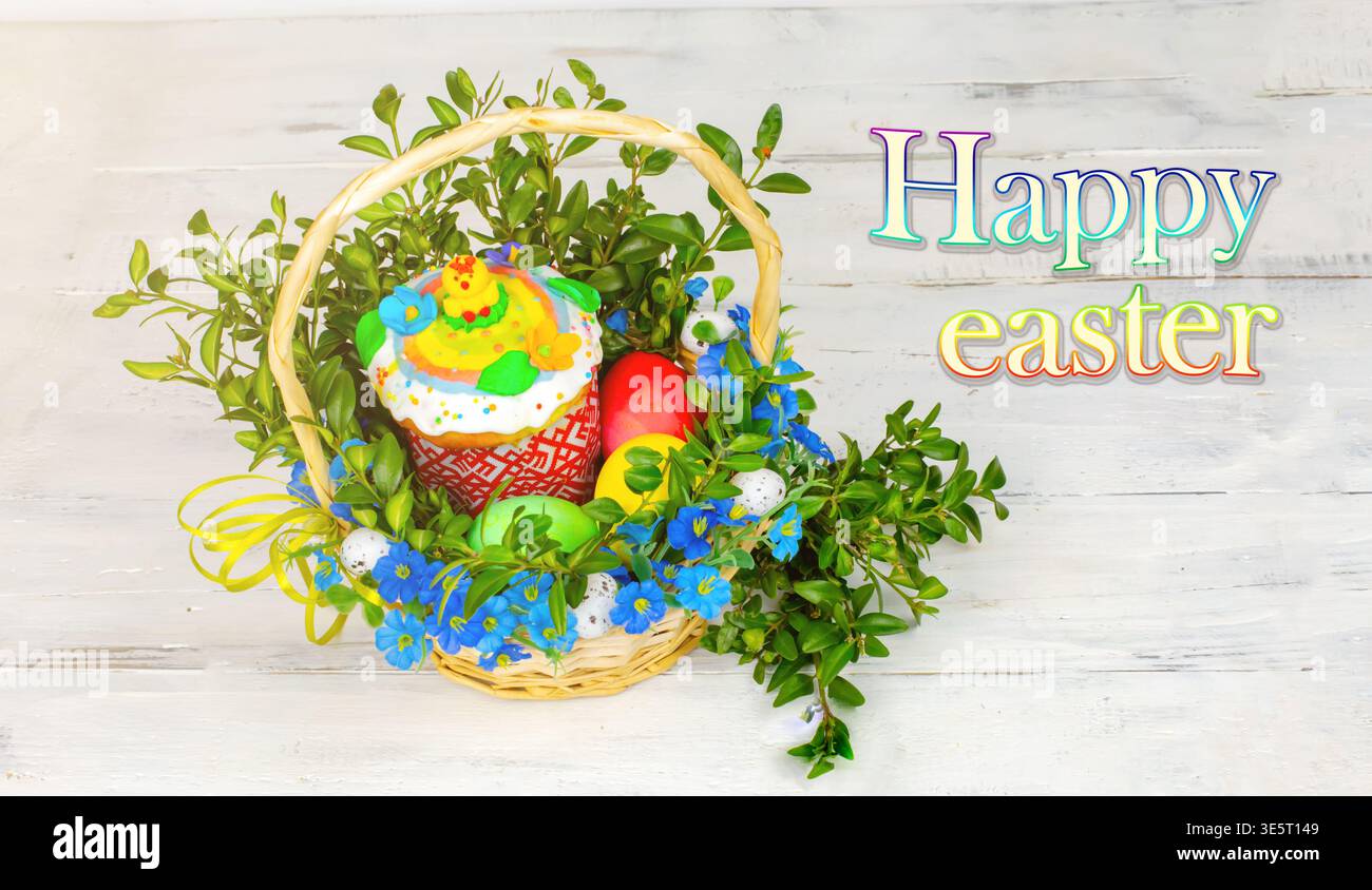 Easter composition. decorated with Easter bread and Easter eggs on the table decorated with herbs and chocolate hare Stock Photo